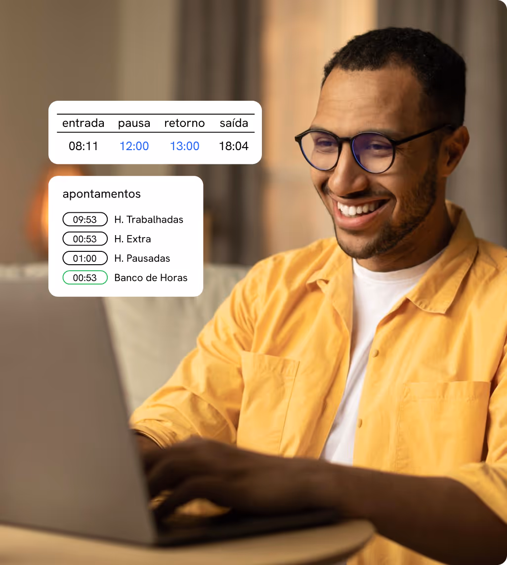 Man smiling in front of a laptop with scheduled shifts displayed on screen.